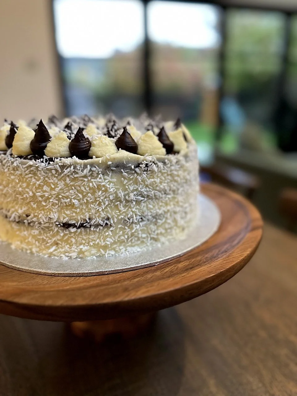 Coconut chocolate flake celebration cake baked in Cambridge UK